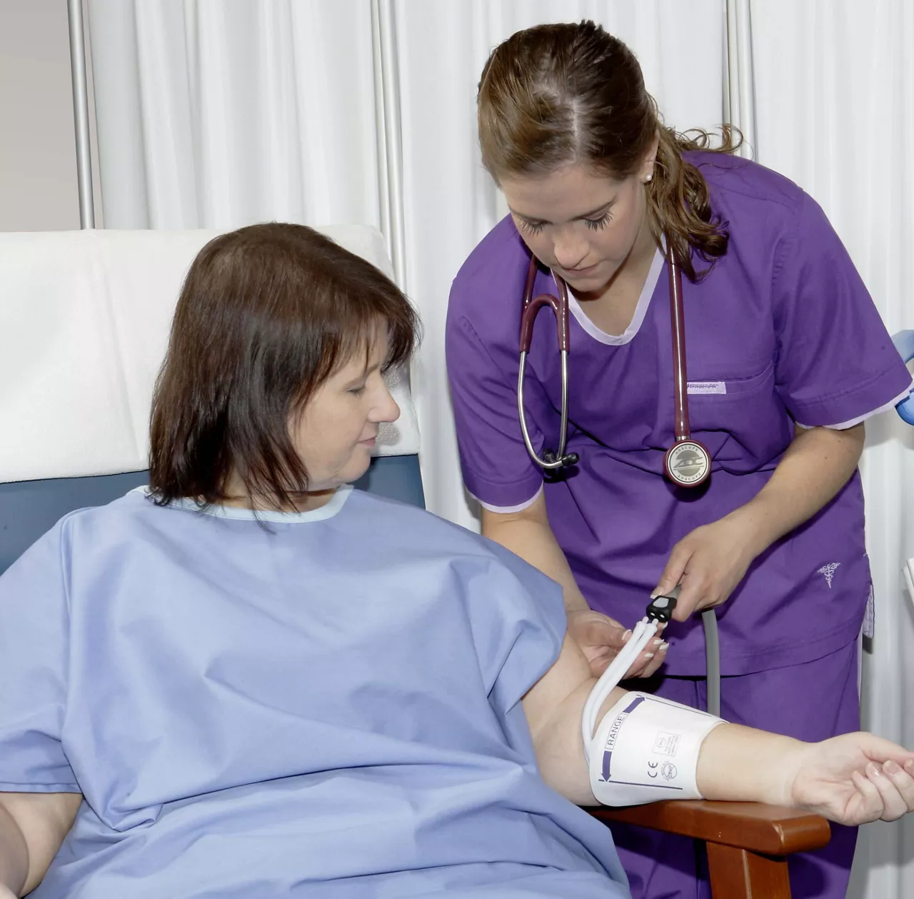 Clinician using a RADIAL-CUF blood pressure cuff on a patient's arm