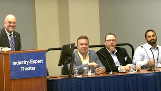 Panel of healthcare and industry experts seated at an Industry Expert Theater, participating in a conference discussion.