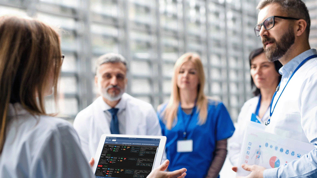 clinical leader providing report out to four healthcare practioners