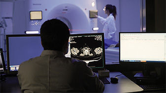 A clinician looking at scans from a CT