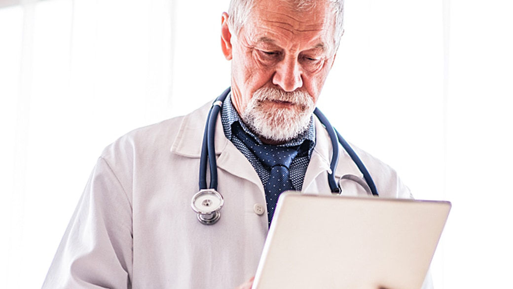 Clinician working at a tablet.