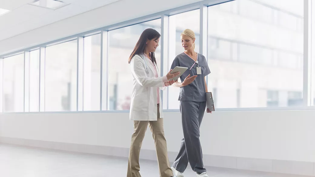Clinicians working in a hallway.