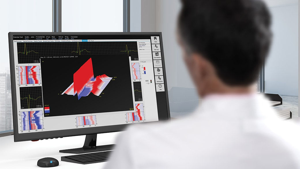 Clinician reviewing scans on a computer monitor.