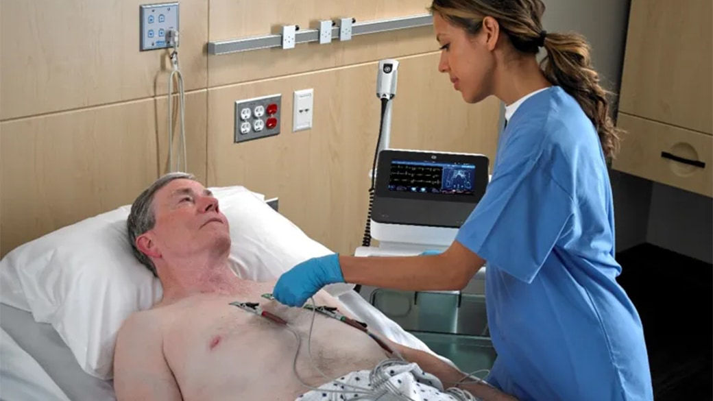 Clinician placing ECG leads on a patient.