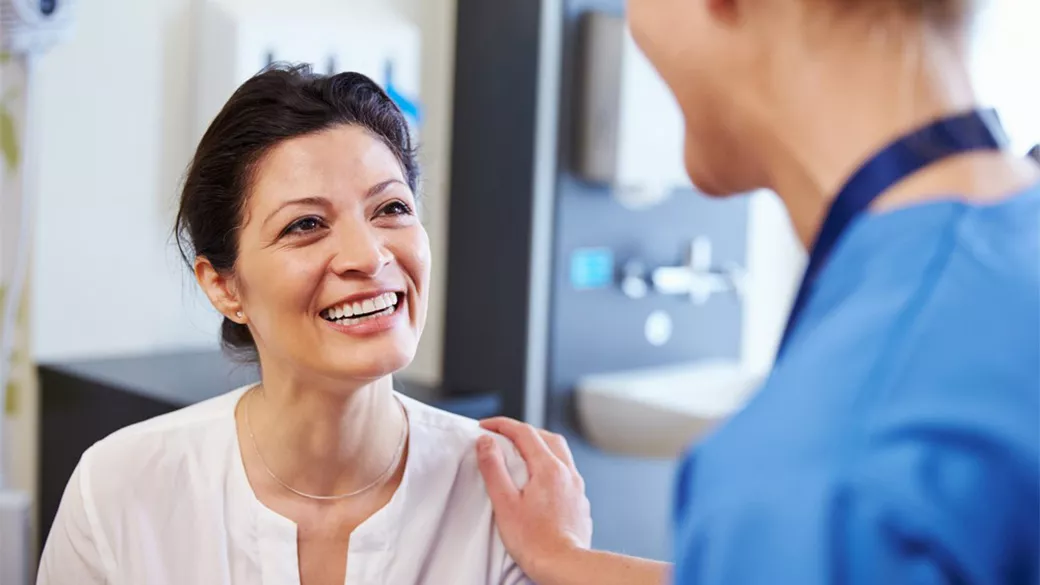 A patient smiling at a clinician