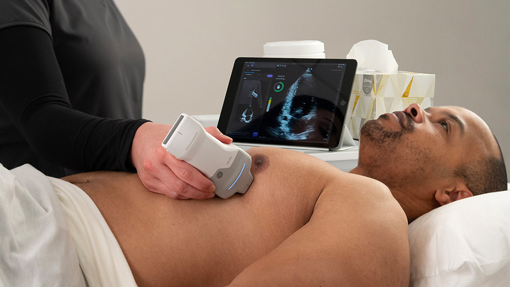 Image of a clinician using AI in a bedside Echo Lab assessment.