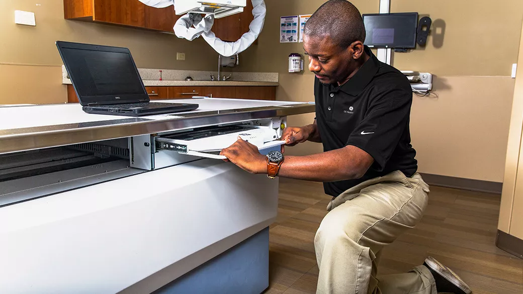 Technician repairing medical equipment.