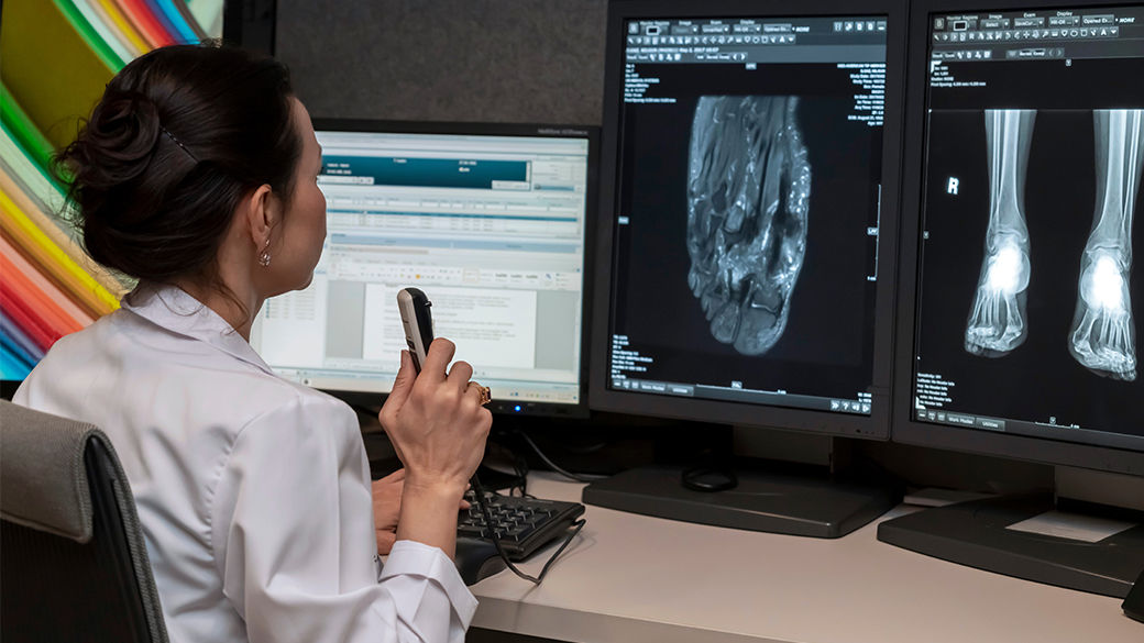 Clinician looking at scans on a computer