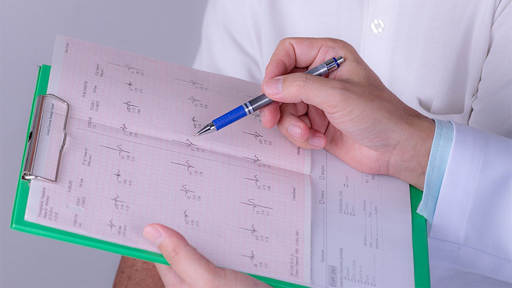 Clipboard with cardiac readings on it.