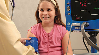Pediatric patient having her blood pressure taken