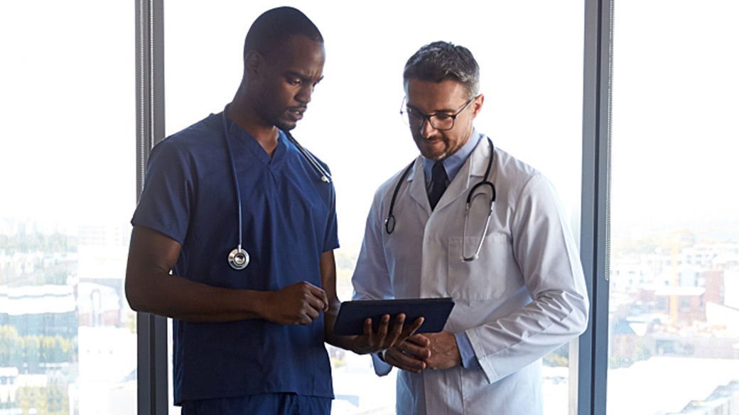 Clinicians talking in a hall way.