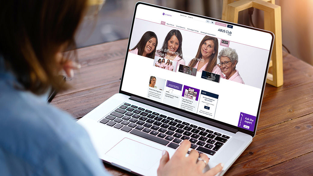 Image of a person using a laptop to view the ABUS Club web page.