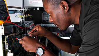 Image of a man working on hardware.