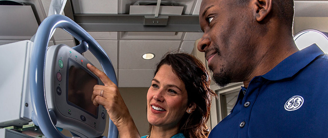 female nurse and male technician looking at a monitor