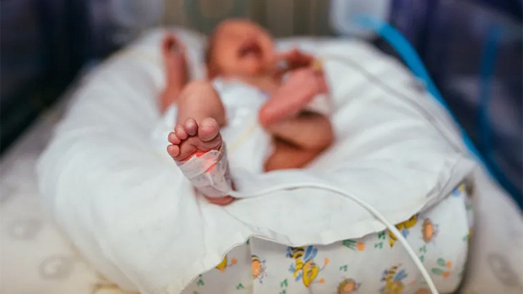 Infant with a sensor on their foot.