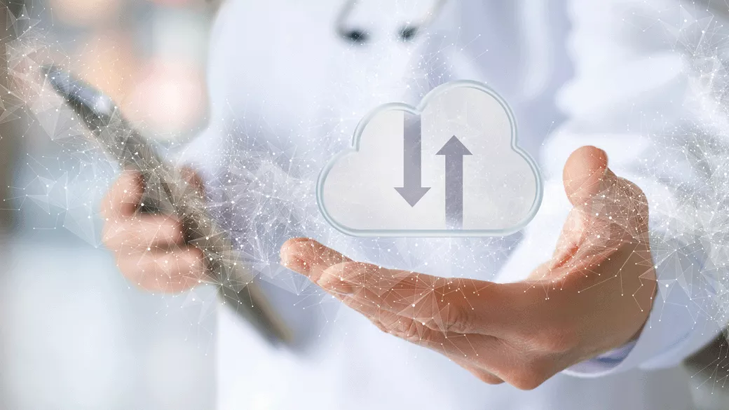 clinician with tablet with cloud graphic overlay