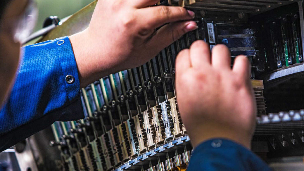 Two hands working on an imaging system