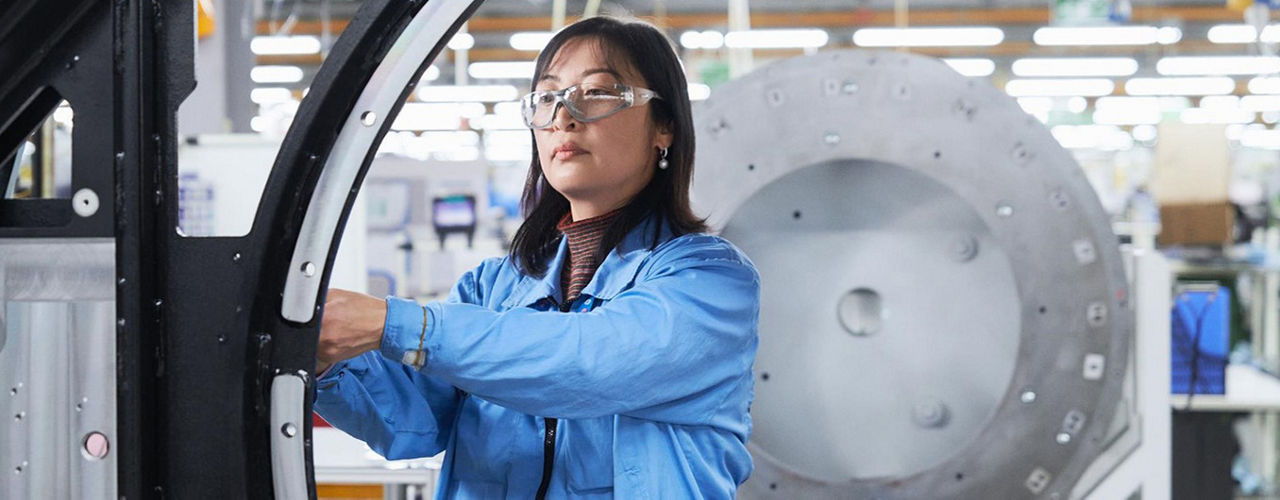 Woman wearing safety glasses and working on an imaging system