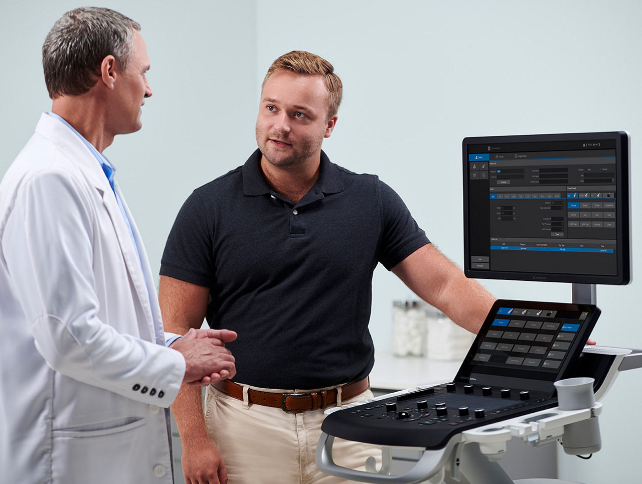 GEHC Service Partner showing doctor a Versana Machine