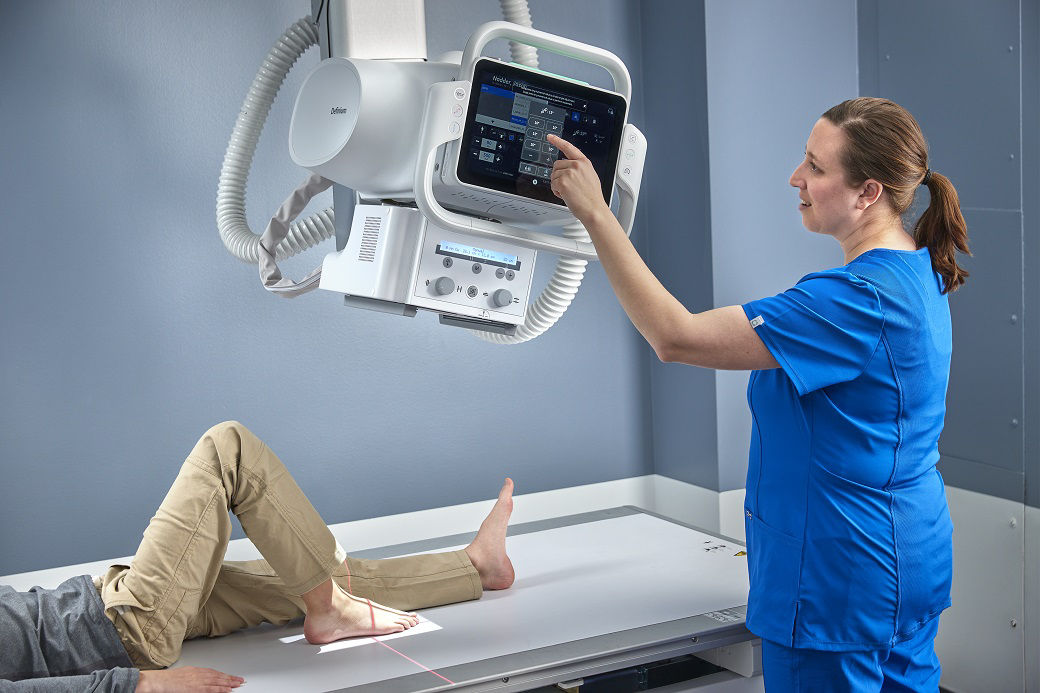 MR technologist screening a male patient for prostate cancer