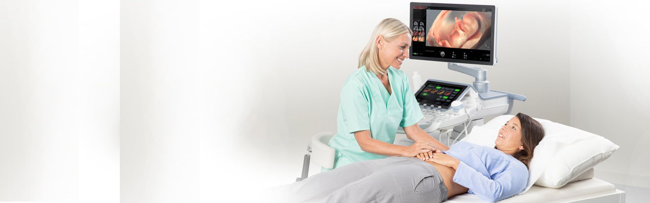 Sonographer using ViewPoint 6 reporting software for obstetrics and gynecology