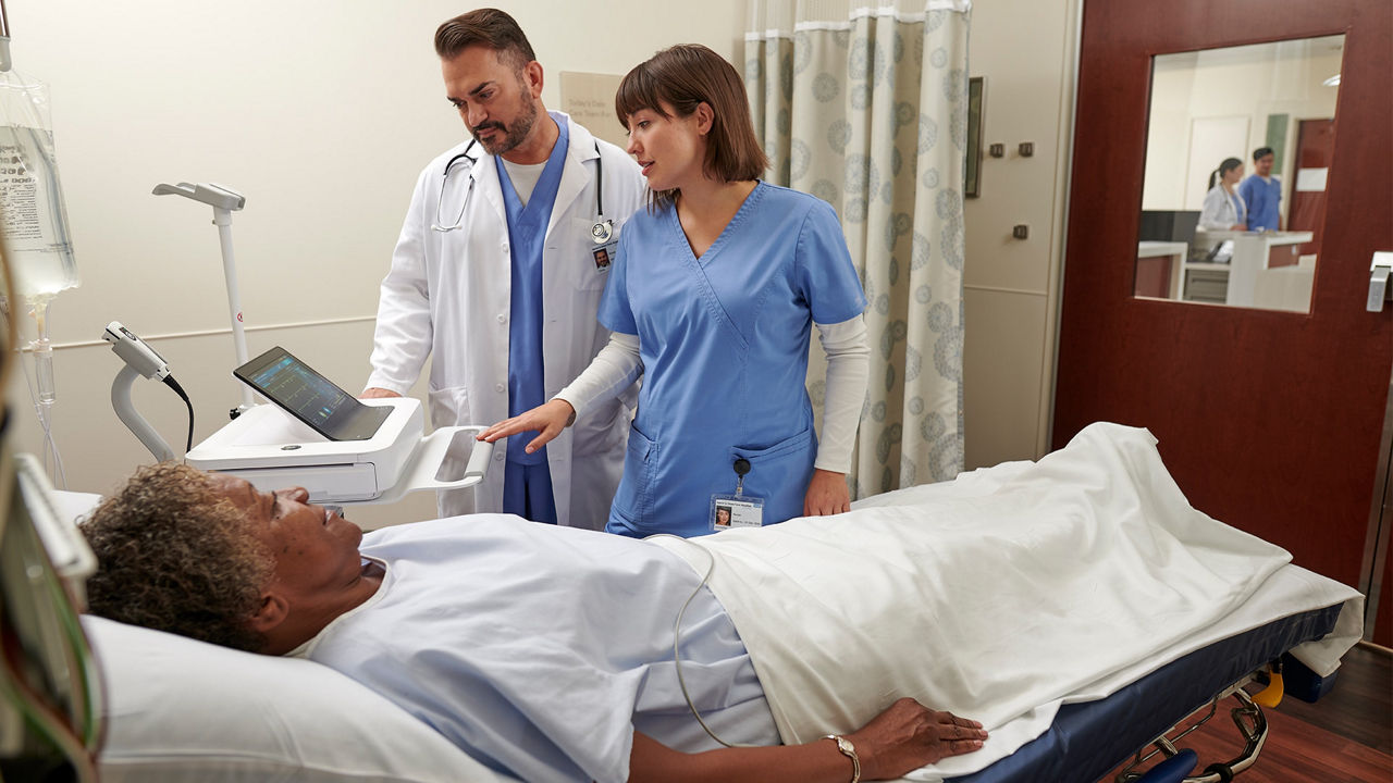 Clinicians assessing a patient bed side.