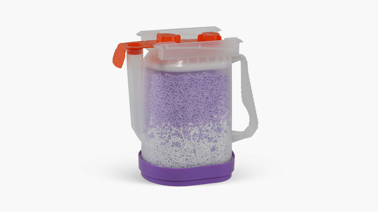 AMSORB plus product of a clear container filled with a filter media.