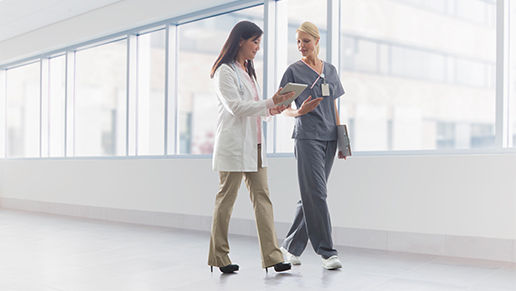 Two clinicians walking a hallway.