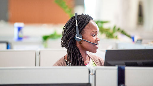 Woman with a headset in a cubicle