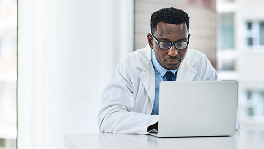 Physician working on a laptop