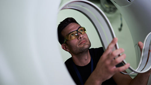 Man holding a flexible strip of material