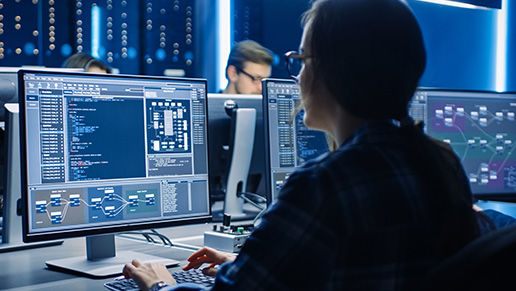 Woman looking at metrics on a computer screen