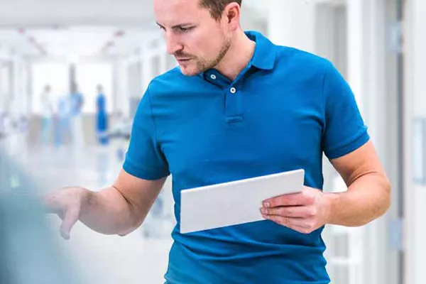 technician looking at tablet