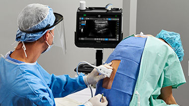 Anesthesiologist using Venue to find nerves on a patient's spine