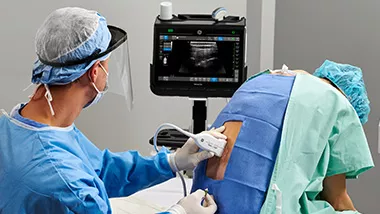 Anesthesiologist using Venue to find nerves on a patient's spine