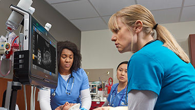 Three doctors working on an emergency patient using Venue