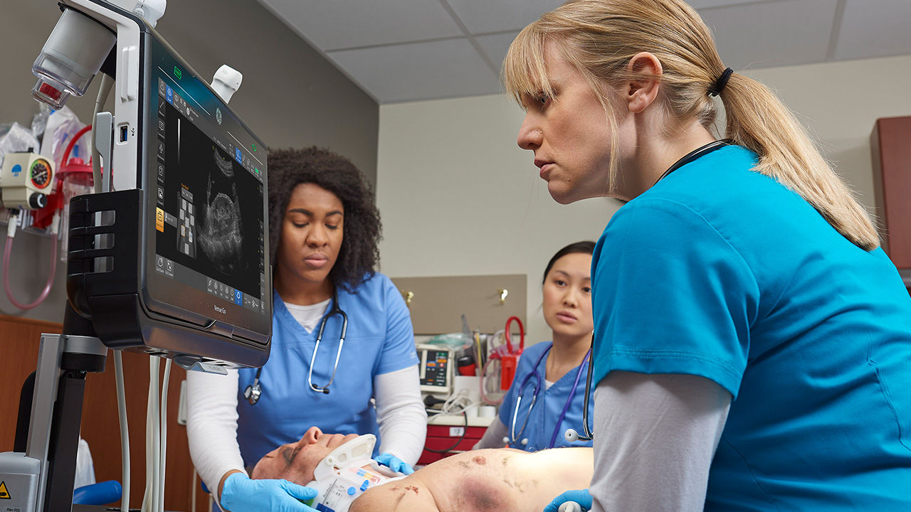 Three doctors working on a patient