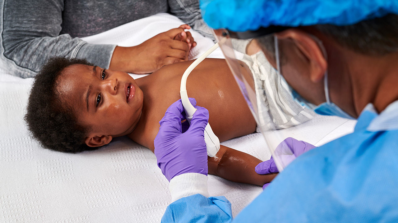 Doctor examining a baby with Venue