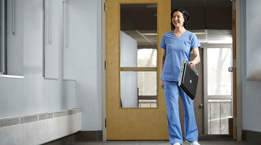 Clinician walking down the hall with portable Ultrasound system