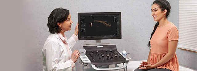 female doctor talking to someone about the ultrasound results on the Versana Balance