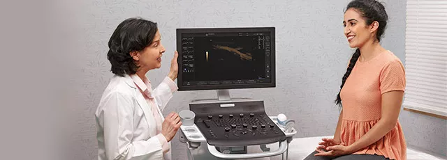 female doctor talking to someone about the ultrasound results on the Versana Balance