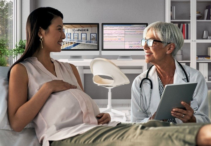 Two clinicians looking at a computer monitor