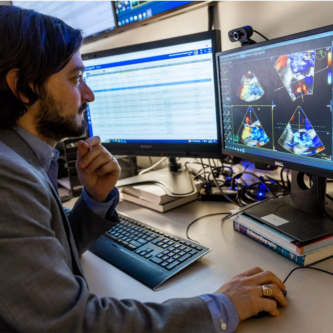 Man reviewing medical scans on a computer