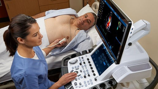 Clinician performing an echocardiogram on a male patient