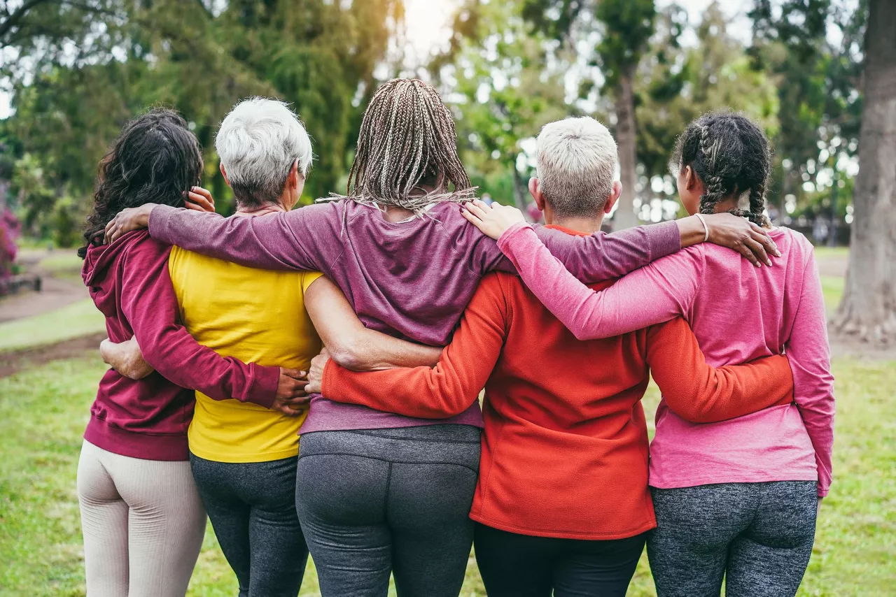 women arms together facing backwards