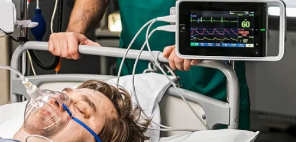 patient with monitor showing stable heart rate