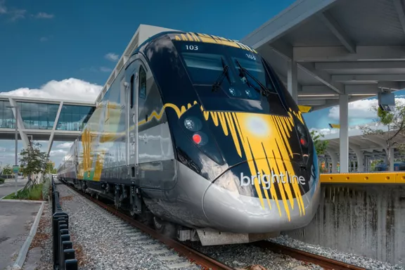 The front of a Brightline train stopped at a station