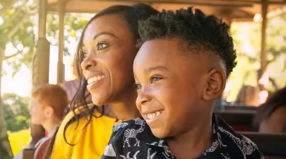 Mom and son enjoying the view of animals