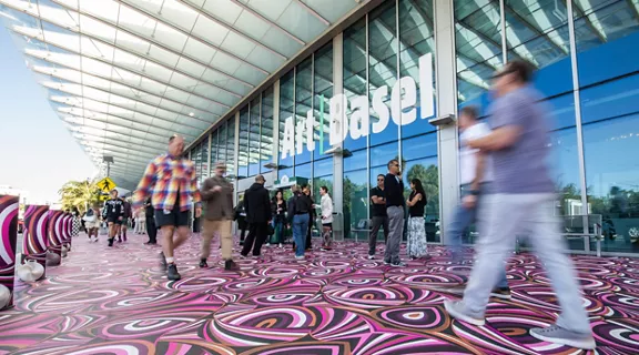 A small crowd of Art Basel attendees outside the convention center in Miami Beach, Florida