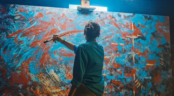 A woman creating an abstract painting.